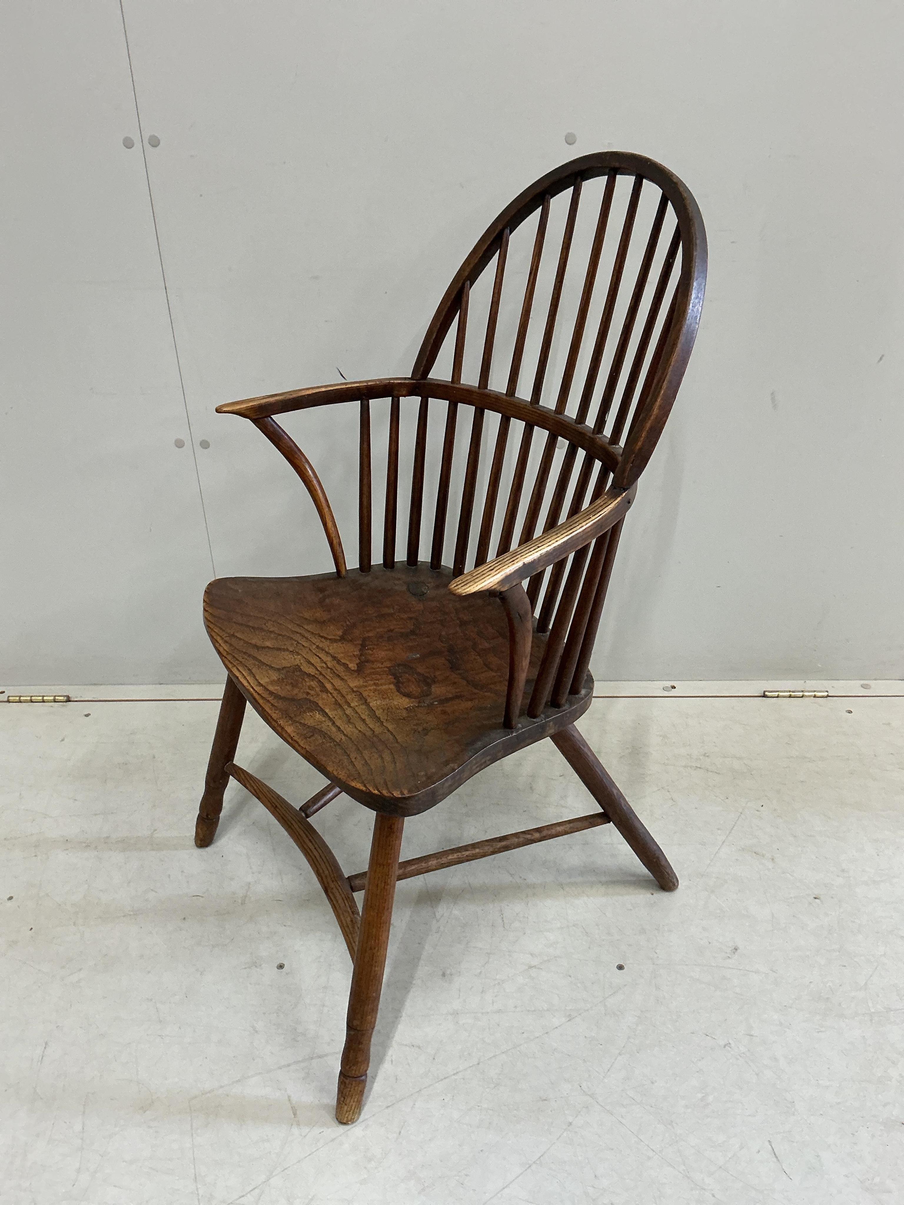 An early 19th century West Country ash and elm Windsor comb back elbow chair, width 57cm, depth 40cm, height 94cm